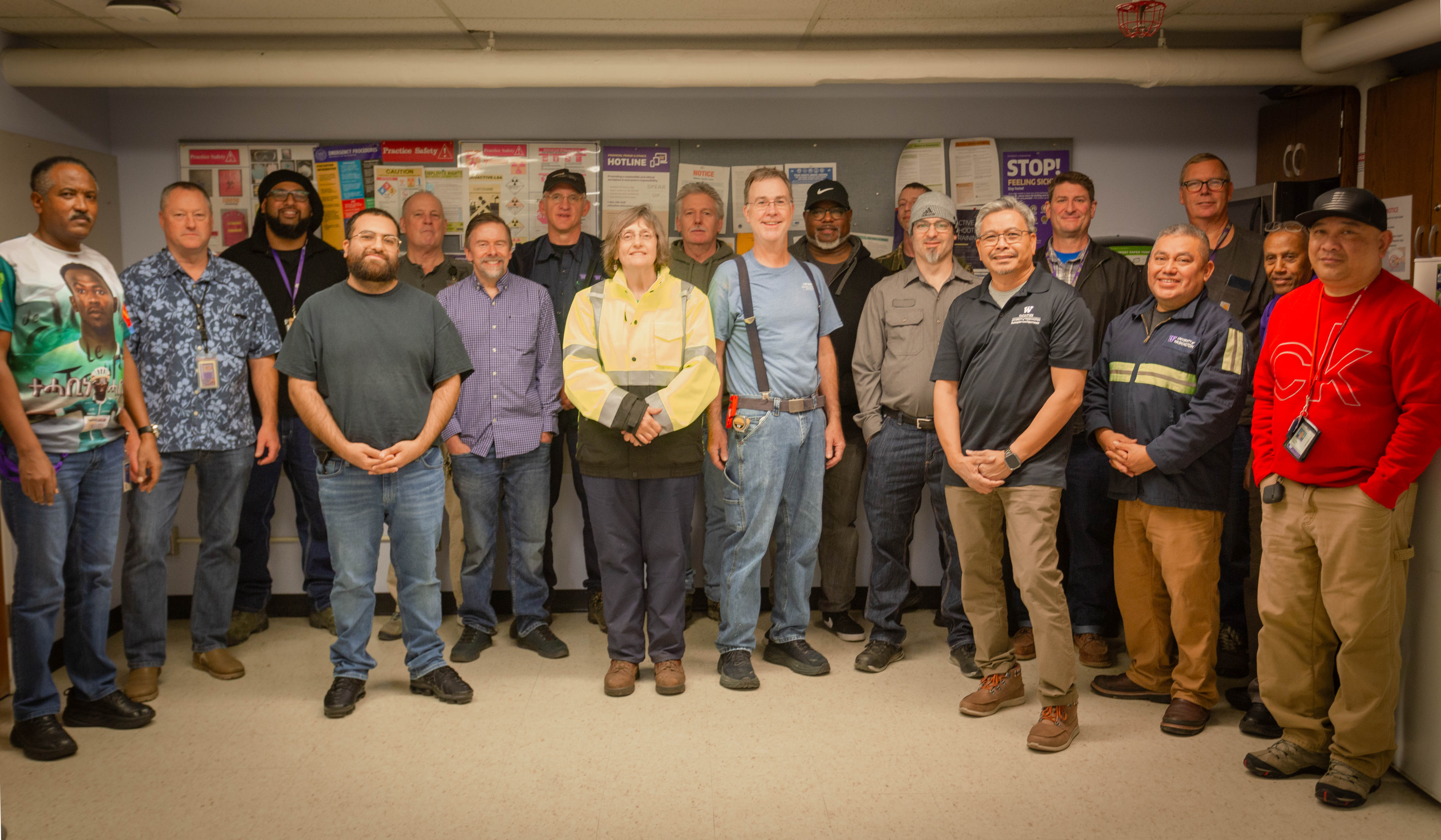 group of people standing in a breakroom