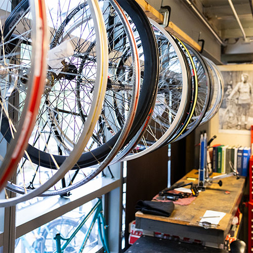 bikes hanging on the wall with a desk in the background